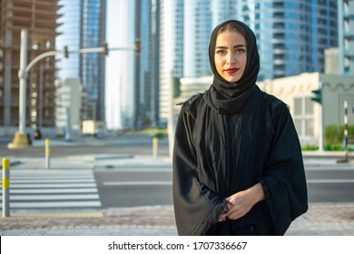 Portrait of beautiful middle eastern woman wearing abaya on the street