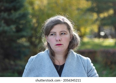 Portrait of a beautiful middle-aged woman with long hair who walks in the park - Powered by Shutterstock