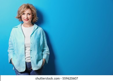 Portrait Of Beautiful Middle-aged Woman On Blue Background