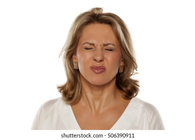 Portrait of beautiful middle-aged woman with sour gesture