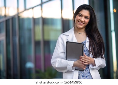 Portrait of a beautiful mixed ethnicity Hispanic Indian woman, medical professional, student, intern, or assistant at the workplace - Powered by Shutterstock