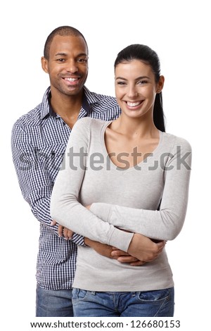 Portrait of beautiful mixed race couple, embracing, smiling, looking at camera.
