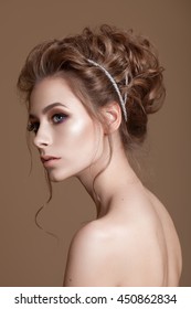 Portrait Of Beautiful Model With Big  Eyes On Brown Background. Bridal Makeup And Hairdo