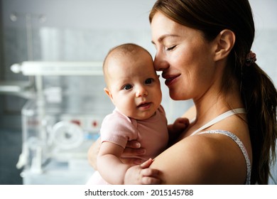 Portrait Of Beautiful Mother With Her Baby In The Hospital Background