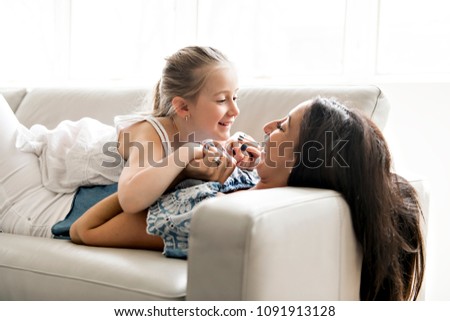 Similar – child girl playing checkers with her dad at home