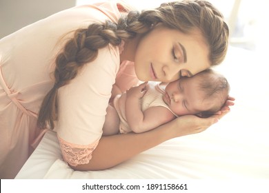 Portrait of a beautiful mother, with her nursing baby. High quality photo.