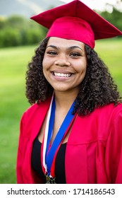 Portrait of a beautiful multi-ethnic woman wearing her graduation cap and gown. Selective focus on her beautiful face