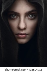 portrait of a beautiful mysterious girl in the hood closeup