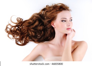 Portrait Of The Beautiful Nice Woman With Red Long Ringlets Hair