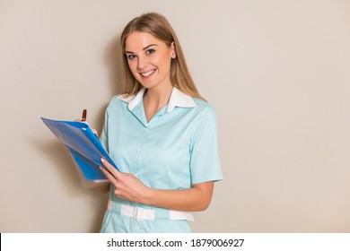 Portrait Of Beautiful Nurse Writing Notes.