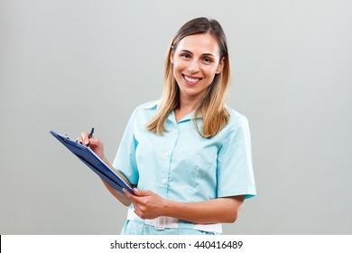 Portrait Of Beautiful Nurse Writing Notes.Beautiful Nurse Writing Notes