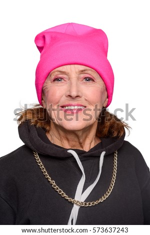 Portrait of beautiful old lady in hip-hop style clothes. Senior woman is glad, she smiles looking right at the camera. Vertical shot with isolation on white.