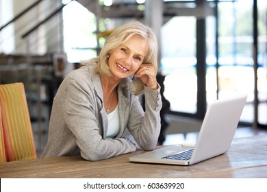 Portrait Of Beautiful Older Woman Working Laptop Computer Indoors