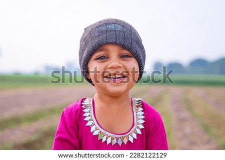 Portrait of beautiful Pakistani kid laughing. Beautiful Pakistani kid beautifully posing against blurred background. Asian kid. Kid model photography.  Village baby girl from Punjab Pakistan. 