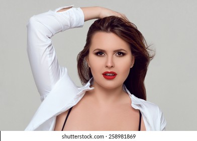 Portrait Of Beautiful Plus Size Curly Young Woman With Make Up 