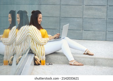 Portrait Of Beautiful Plus Size Woman 30-35 Years Old In Fashion Clothes And Eyeglasses Working Remotely On A Laptop On Vacation. Close-up Female Freelancer Typing On A Computer In The Park Outdoors