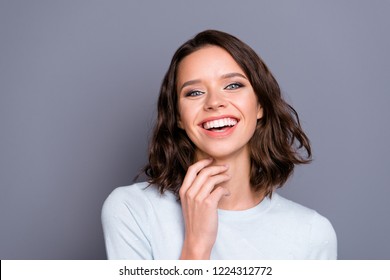 Portrait Of Beautiful Pretty Dreamy Attractive Lady With Her Joke Comic Face Hollywood Smile Brunette Hair She Touch Neck By Hand Look At Camera Stand Isolated On Gray Wall