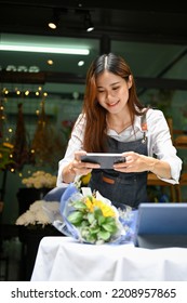 Portrait, Beautiful And Pretty Millennial Asian Female Florist Or Flower Shop Owner Taking A Picture Of Beautiful Bouquet With Her Smartphone.