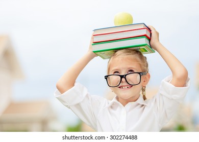 Portrait of Beautiful school girl looking very happy outdoors at the day time. Concept school theme. - Powered by Shutterstock