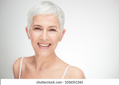 Portrait of beautiful senior woman in front of white background. - Shutterstock ID 1036351342