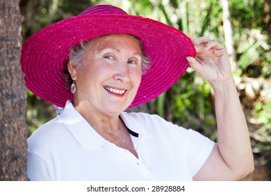 Portrait Of A Beautiful Senior Woman Wearing A Sun Hat.