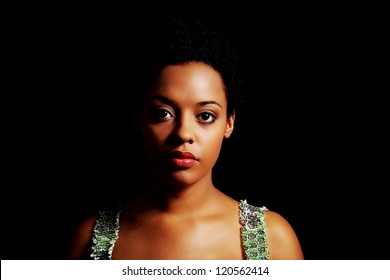 Portrait Of Beautiful Serious Afro American Woman Over Black Background