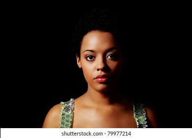 Portrait Of Beautiful Serious Afro American Woman Over Black Background