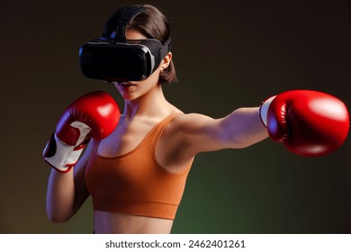 Portrait of beautiful serious woman wearing virtual reality glasses, in boxing gloves, doing punch isolated on black background  - Powered by Shutterstock