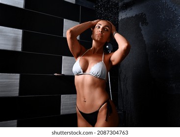 Portrait Of A Beautiful Sexy Blonde Caucasian Woman With Tanned Skin Taking Shower In Spa Bathroom, Enjoying The Freshness And Coolness Of Water