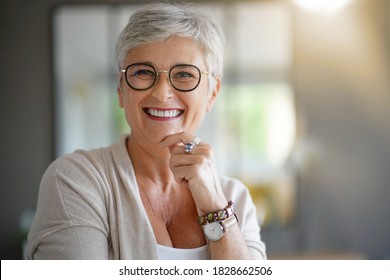 Portrait Of A Beautiful Smiling 55 Year Old Woman With White Hair