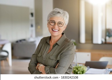 Portrait Of A Beautiful Smiling 55 Year Old Woman With White Hair