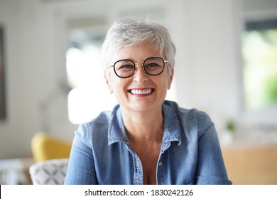 Portrait Of A Beautiful Smiling 55 Year Old Woman With White Hair