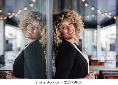 Portrait Of Beautiful Smiling Business Woman Leaning On Glass In Cafe. Business Concept