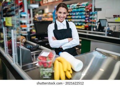Portrait Of Beautiful Smiling Cashier Working At A Grocery Store.