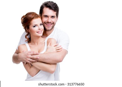 Portrait Of Beautiful Smiling Couple Posing At Studio Over White Background.