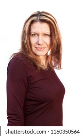 Portrait Of A Beautiful Smiling Middle-aged Woman On A White Background. She Recently Painted Her Hair And Gray Hair Is No Longer Visible - She Is Very Happy About It