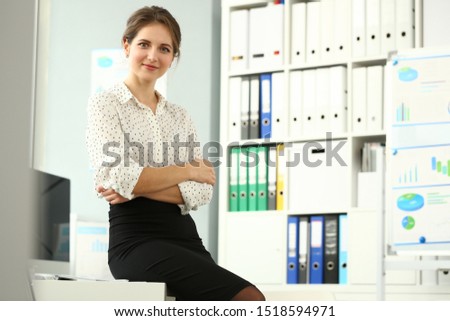 Portrait of beautiful smiling model posing in conference room in office after making important deal. Business and company meeting concept. Blurred background