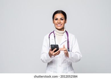 Portrait Of A Beautiful Smiling Nurse. Doctor Woman Use The Phone To Get Treatment Isolated On White Background