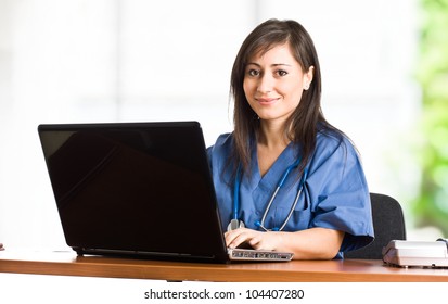 Portrait Of A Beautiful Smiling Nurse Using A Laptop