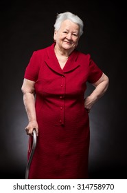 Portrait Of Beautiful Smiling Old Woman On A Dark Background