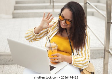 Portrait Of Beautiful And Smiling Stylish Plus Size Business Woman 30-35 Years Old In Yellow Fashion Clothes And Eyeglasses, Working Remotely On A Laptop On Vacation. 