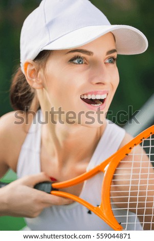 Portrait of beautiful smiling tennis player girl outdoor