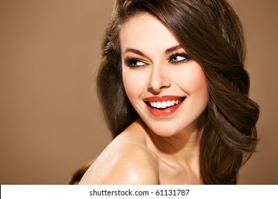 Portrait of beautiful smiling woman isolated on beige with copyspace