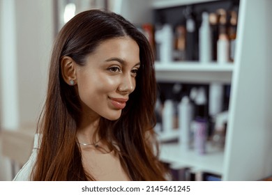 Portrait Of Beautiful Smiling Woman With Long Shiny Dark Hair At Beauty Salon. Hair Care Concept