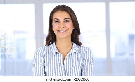 Portrait of Beautiful Smiling Woman Looking at Camera in Office - Shutterstock ID 720383680