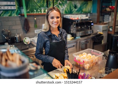 Portrait Of A Beautiful Smiling Woman Working At Juice Bar.