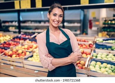 Portrait of beautiful smiling worker in grocery store.