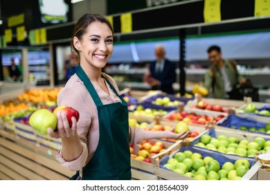 Portrait of beautiful smiling worker in grocery store. - Powered by Shutterstock