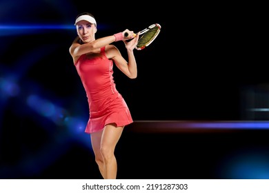 Portrait Of Beautiful Sporty Girl In Uniform Playing Tennis On Black Studio Background