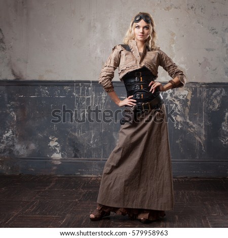 Portrait of a beautiful steampunk woman in Aviator glasses over grunge background.
